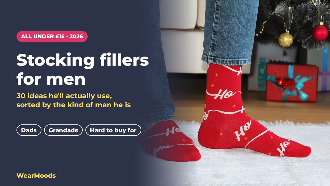 Man wearing red Ho Ho Christmas socks by the Christmas tree
